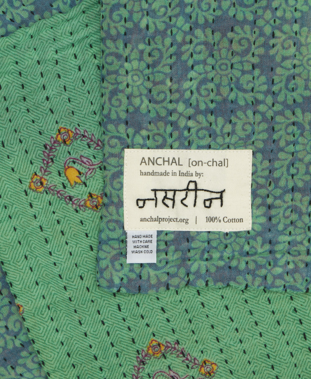 small kantha blanket with signature of the maker on the tag