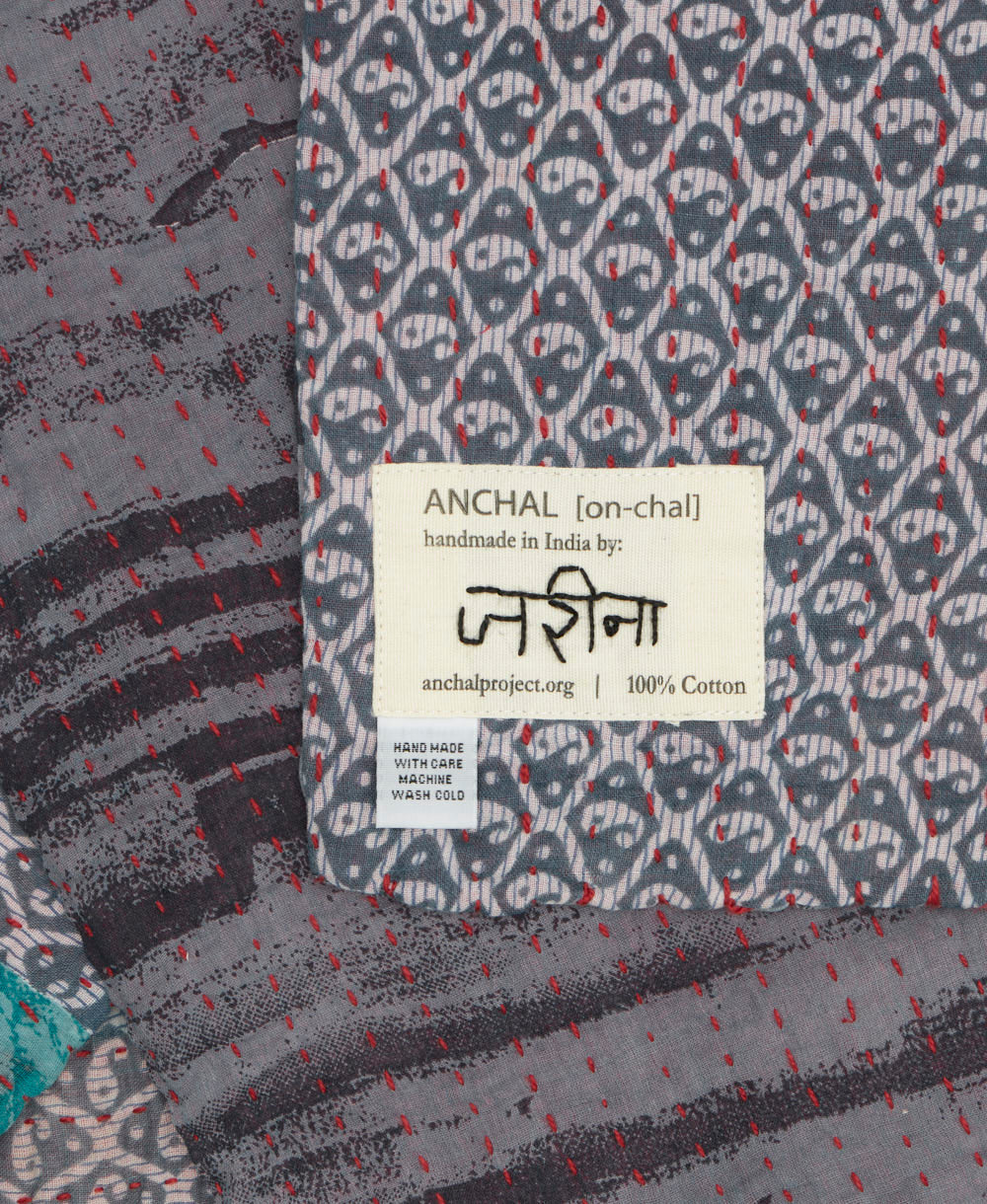 small kantha blanket with signature of the maker on the tag