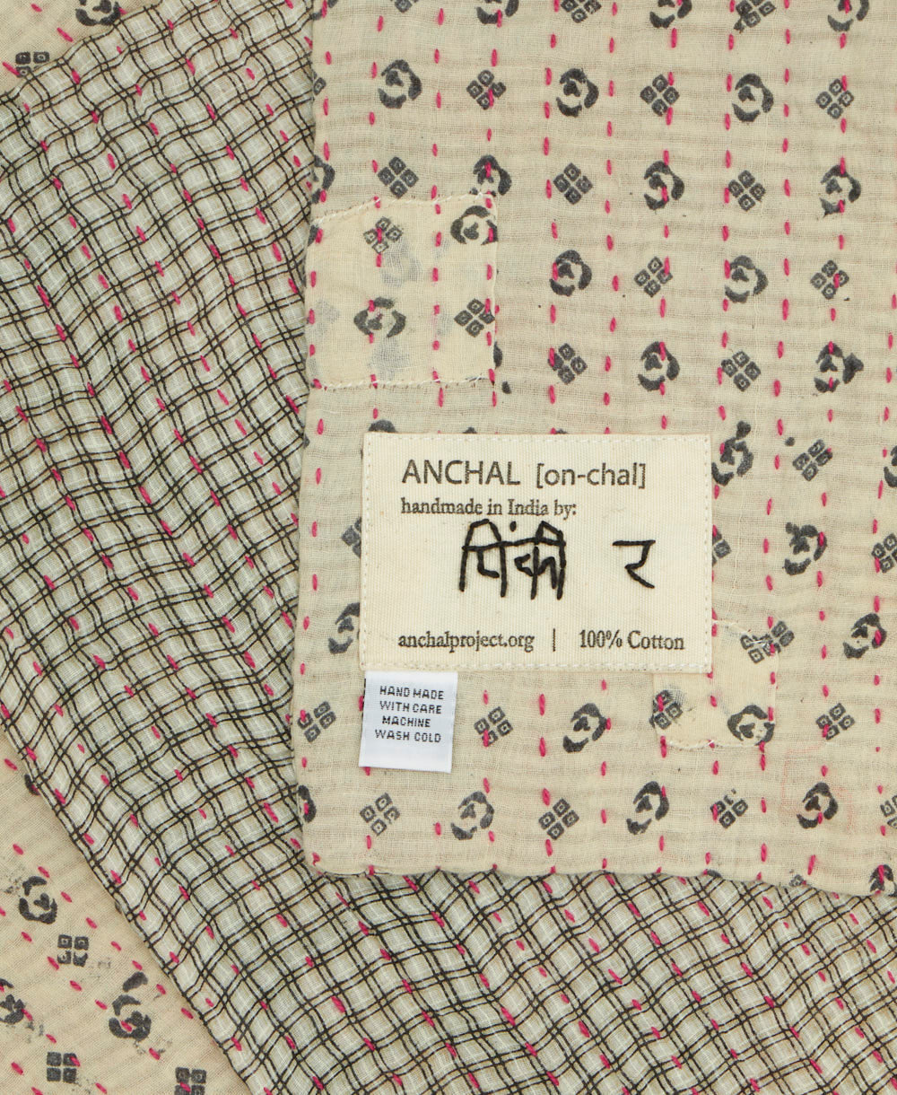 small kantha blanket with signature of the maker on the tag