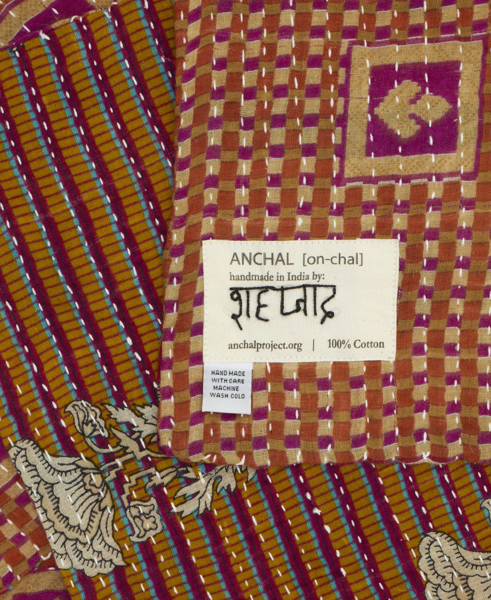 small kantha blanket with signature of the maker on the tag