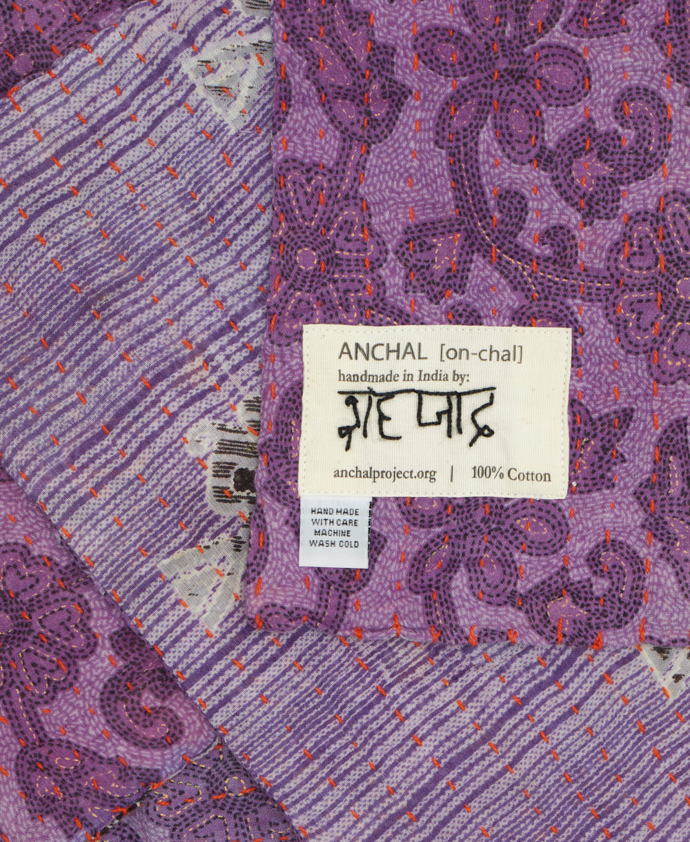 small kantha blanket with signature of the maker on the tag