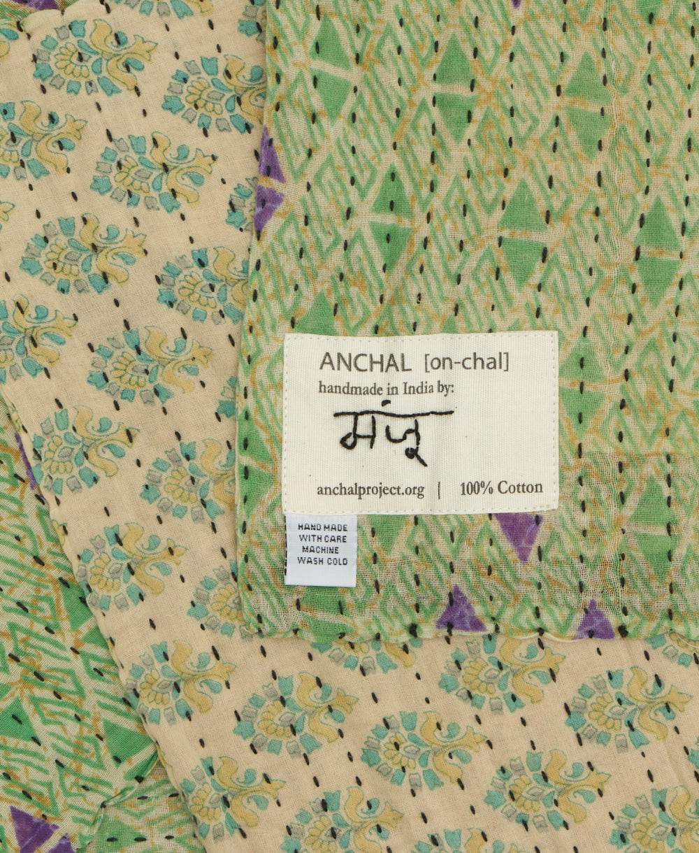 small kantha blanket with signature of the maker on the tag