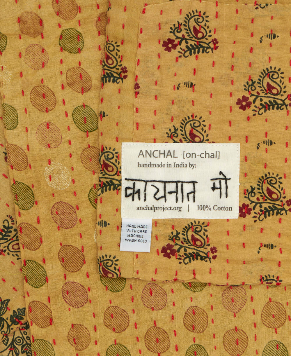 small kantha blanket with signature of the maker on the tag