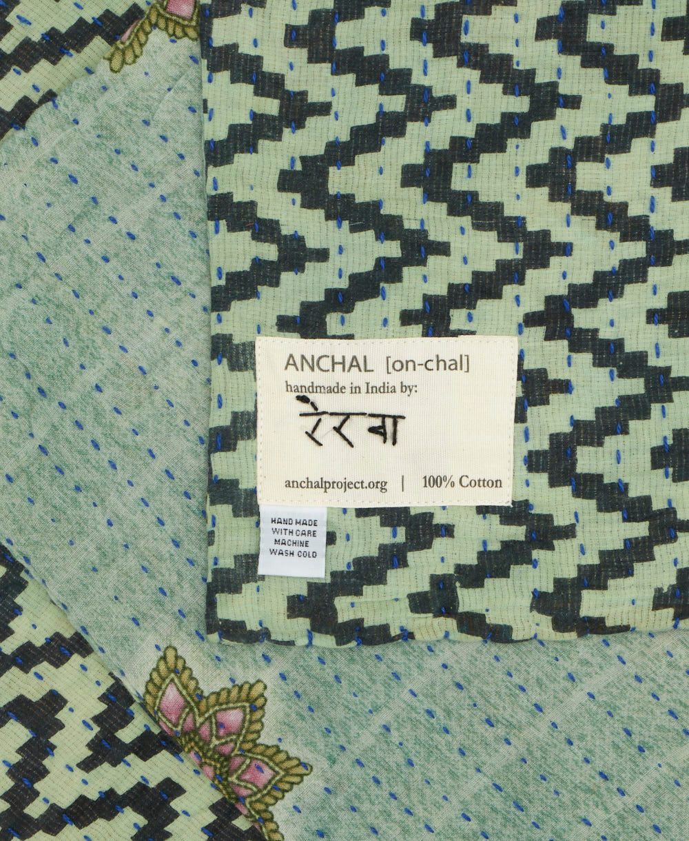 small kantha blanket with signature of the maker on the tag