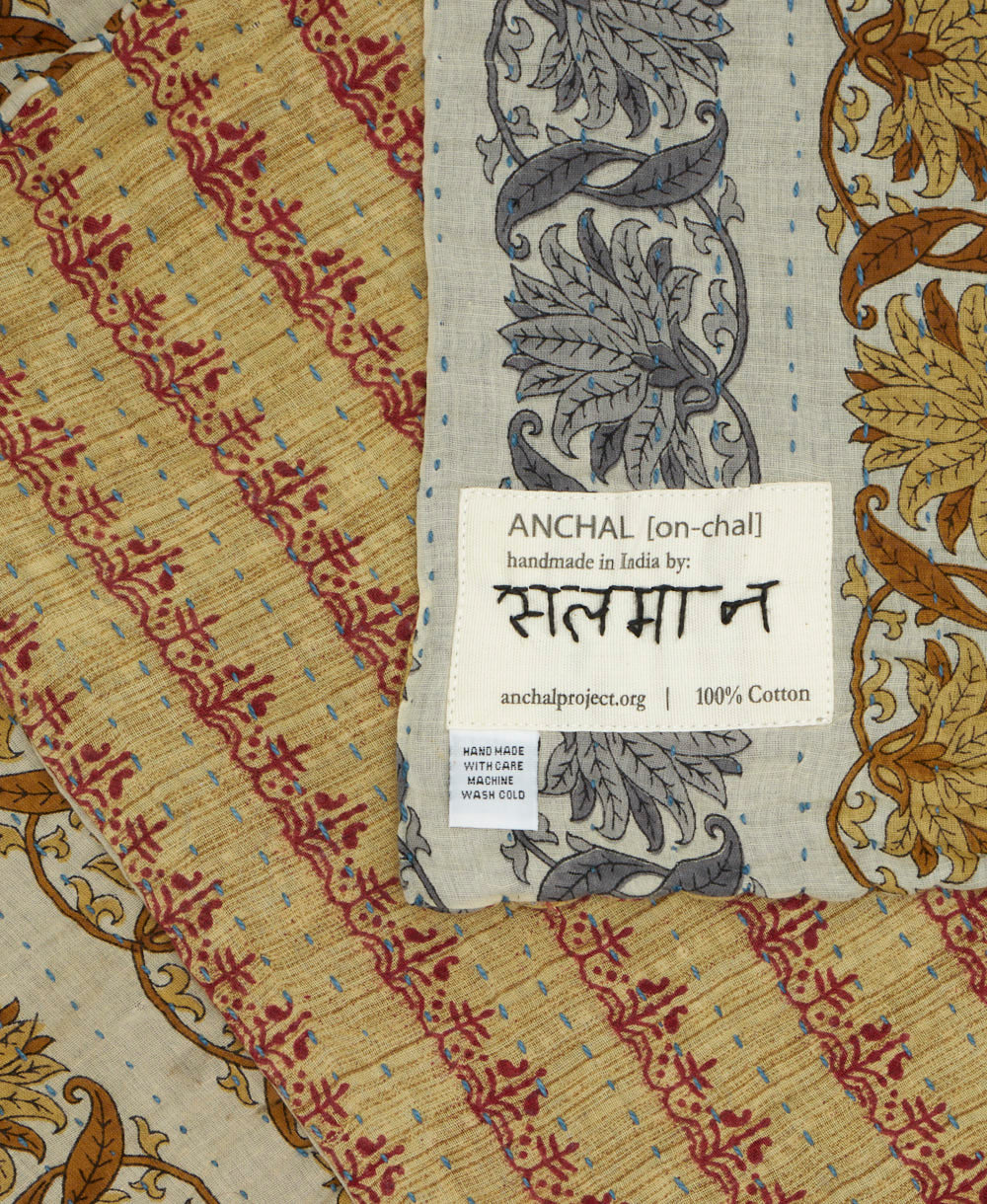 small kantha blanket with signature of the maker on the tag