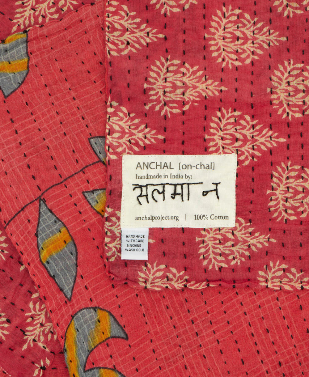 small kantha blanket with signature of the maker on the tag