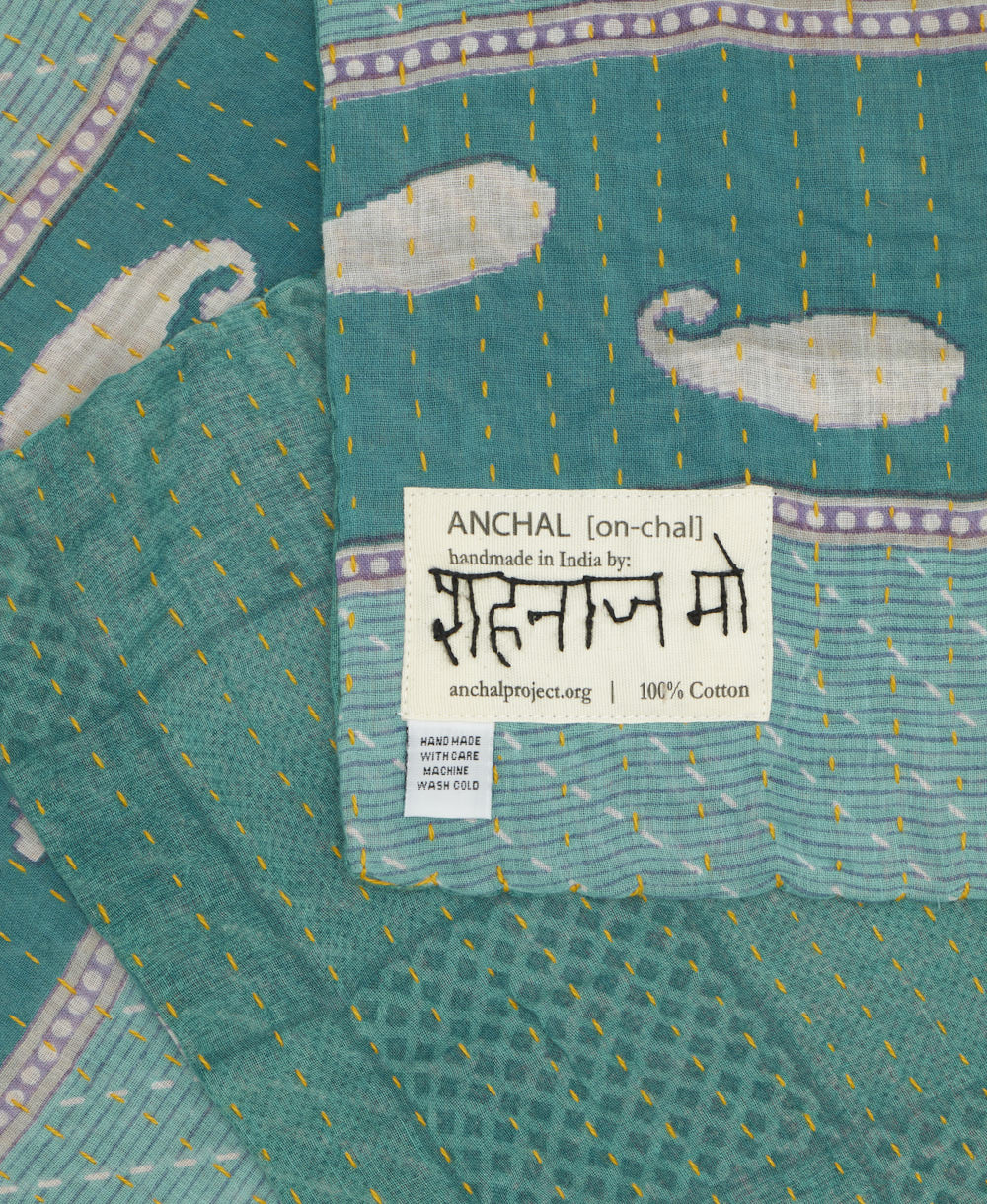 small kantha blanket with signature of the maker on the tag