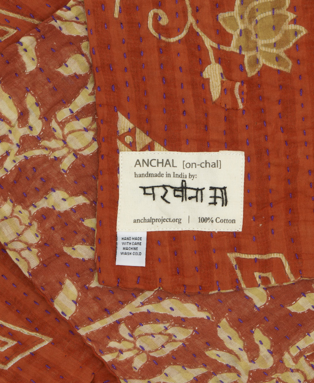 small kantha blanket with signature of the maker on the tag
