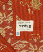 small kantha blanket with signature of the maker on the tag