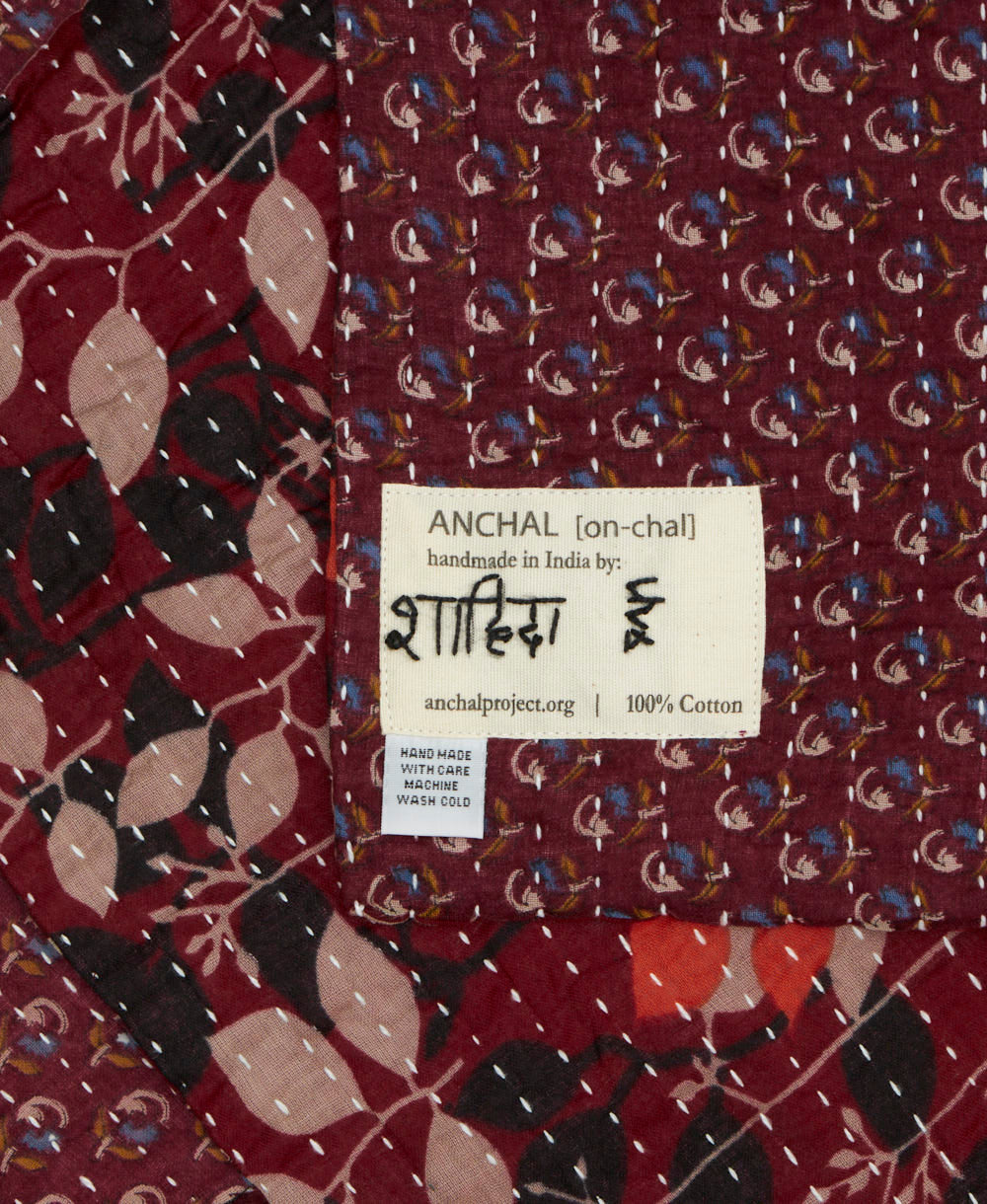 small kantha blanket with signature of the maker on the tag