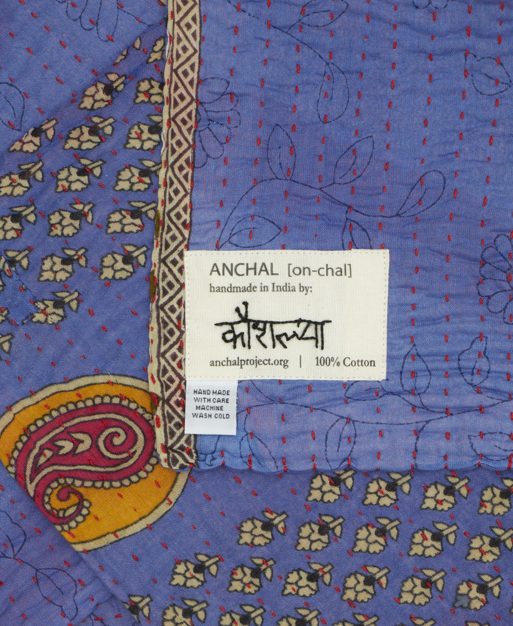 small kantha blanket with signature of the maker on the tag
