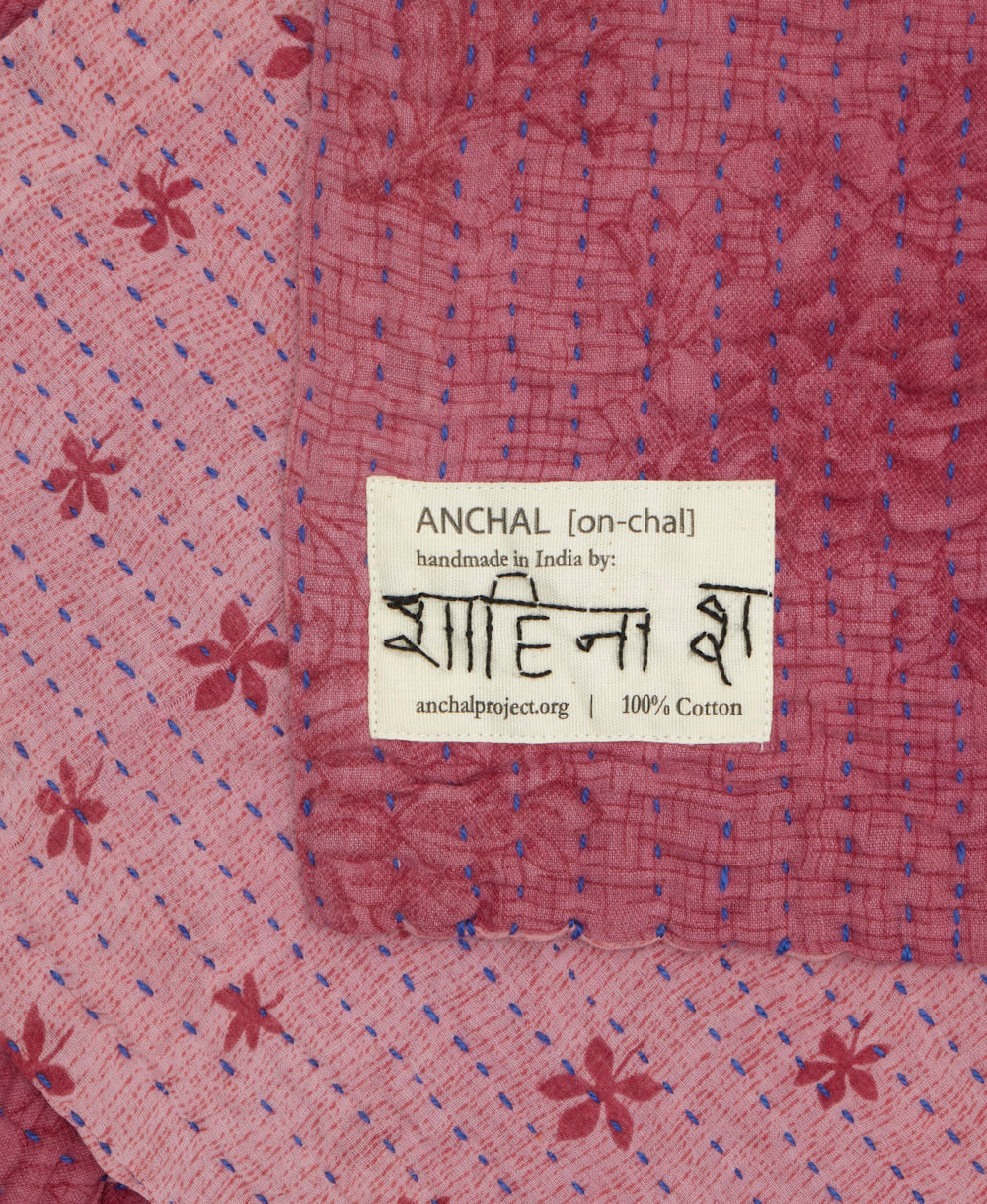 small kantha blanket with signature of the maker on the tag