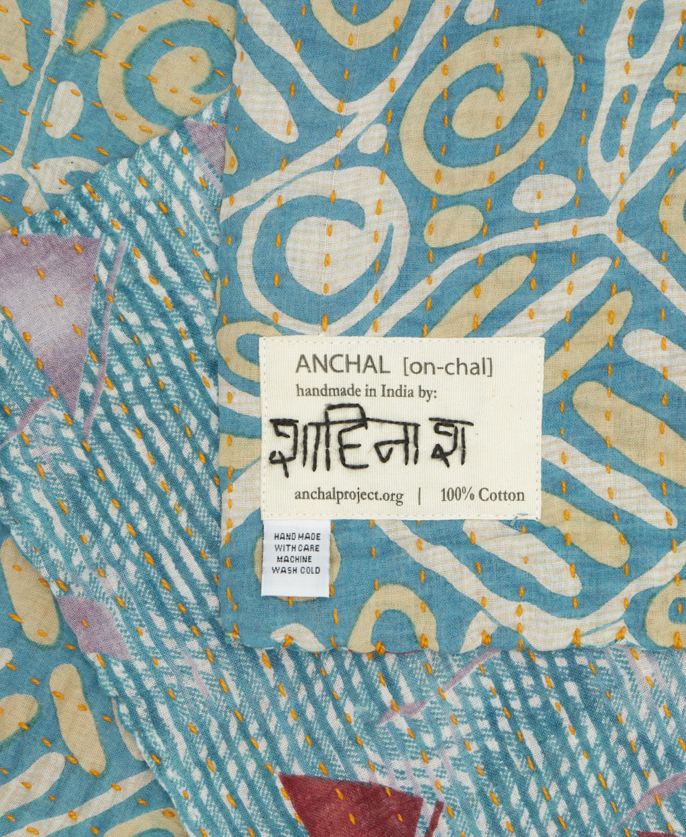 small kantha blanket with signature of the maker on the tag