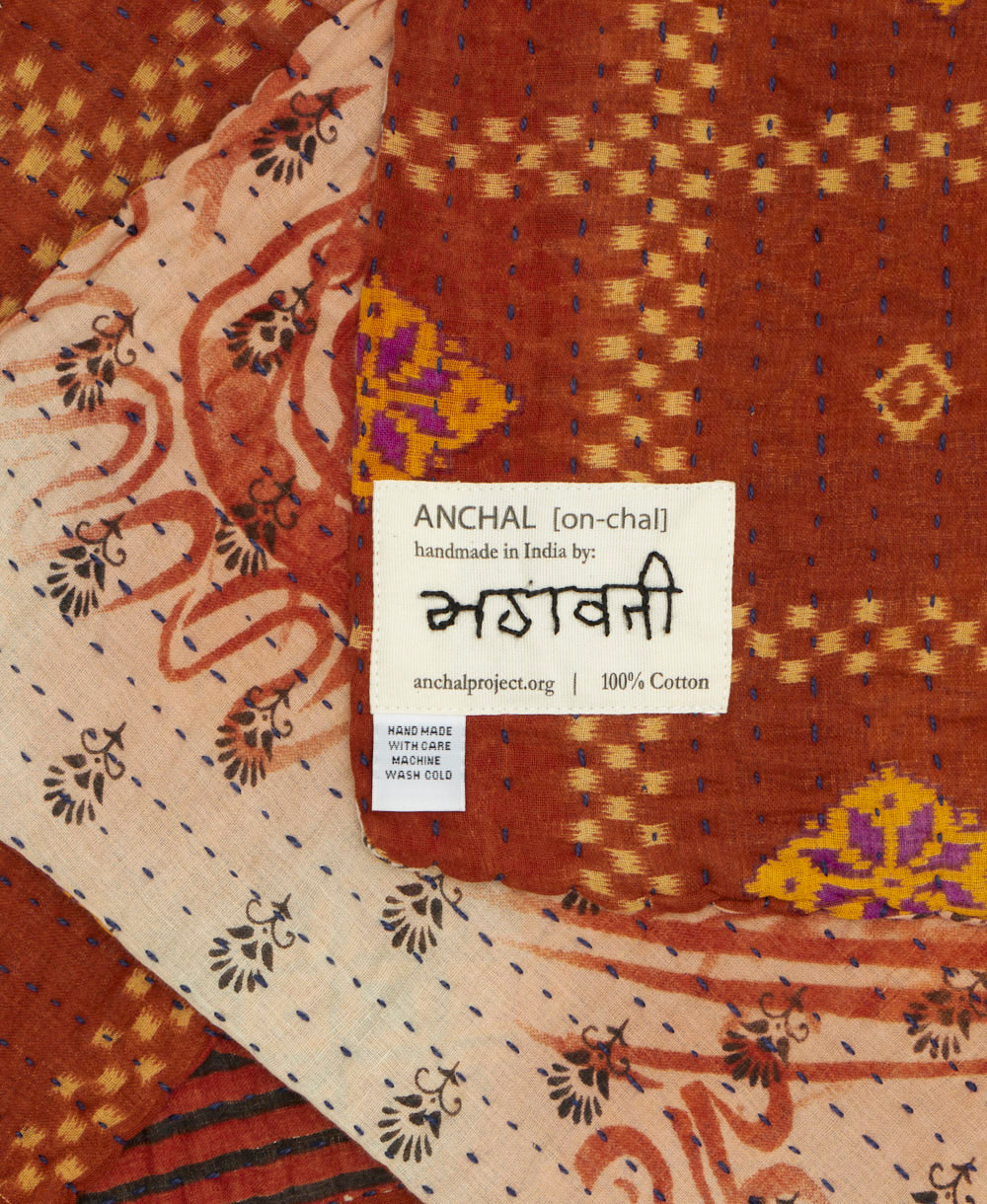 small kantha blanket with signature of the maker on the tag