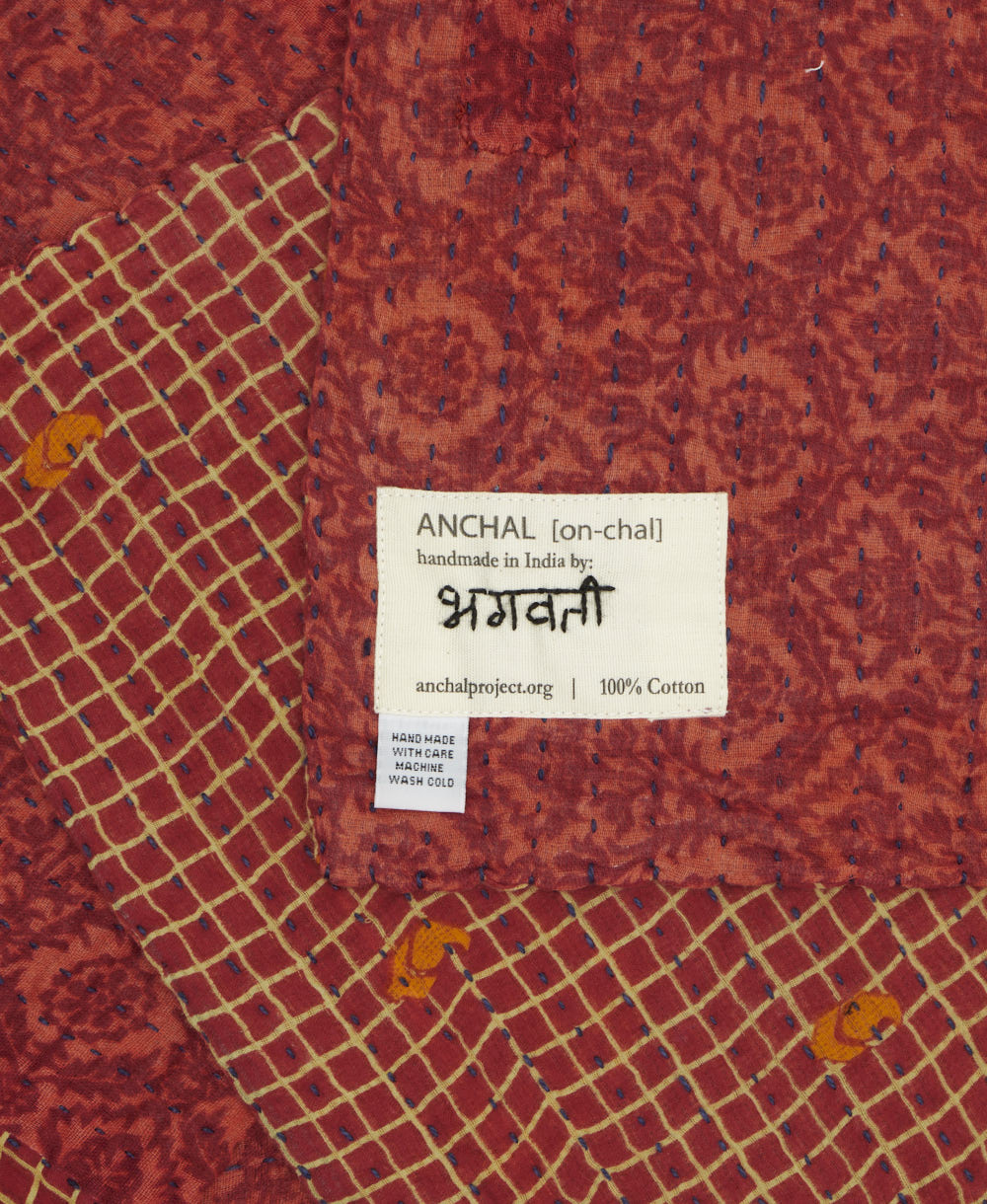small kantha blanket with signature of the maker on the tag
