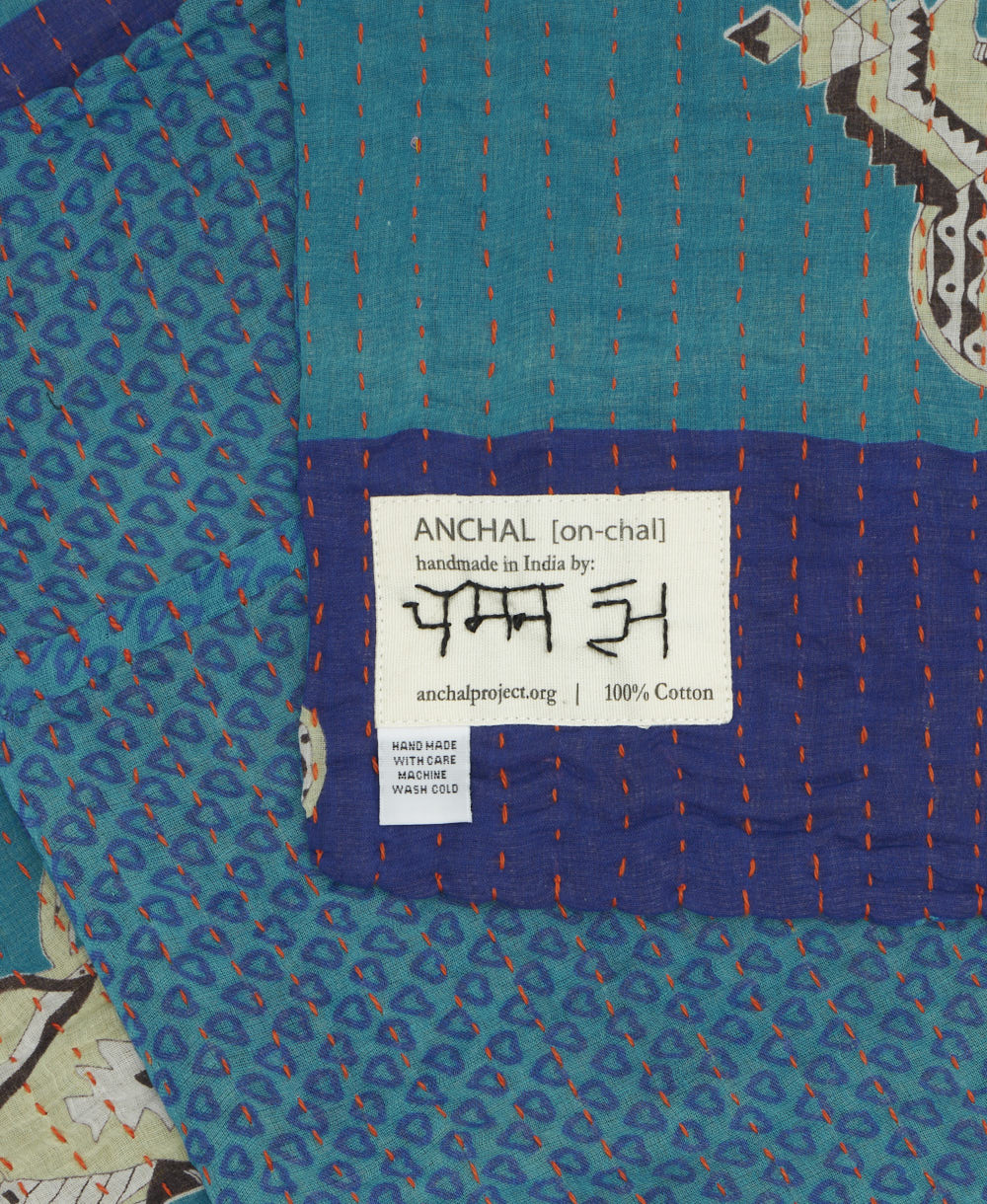 small kantha blanket with signature of the maker on the tag