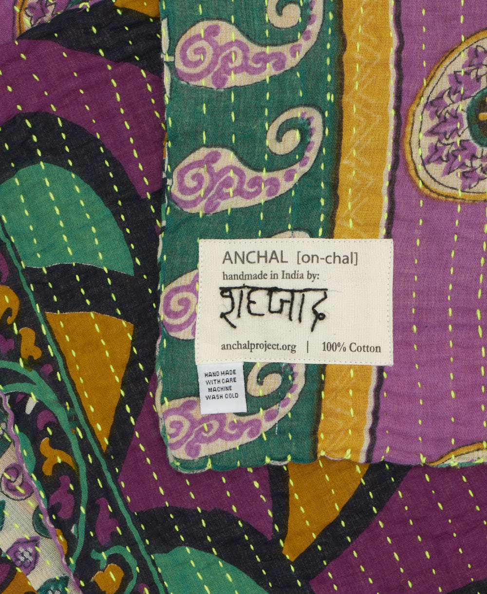 small kantha blanket with signature of the maker on the tag