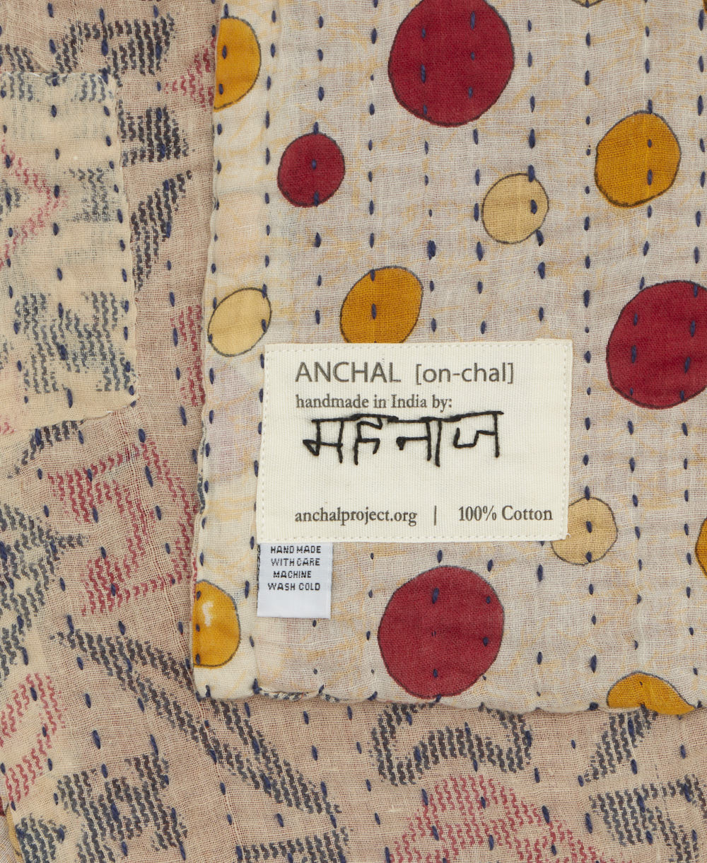 small kantha blanket with signature of the maker on the tag