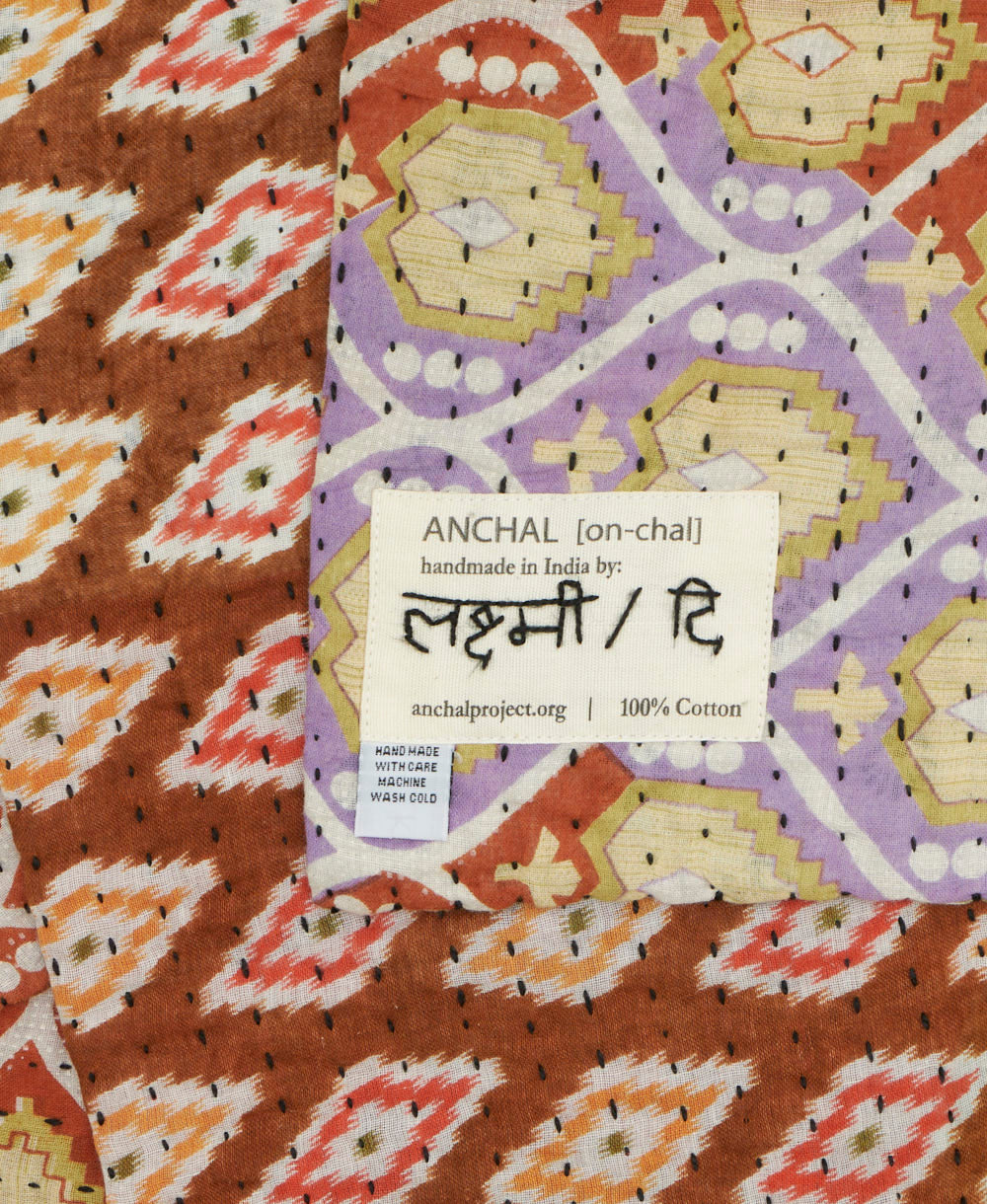 small kantha blanket with signature of the maker on the tag