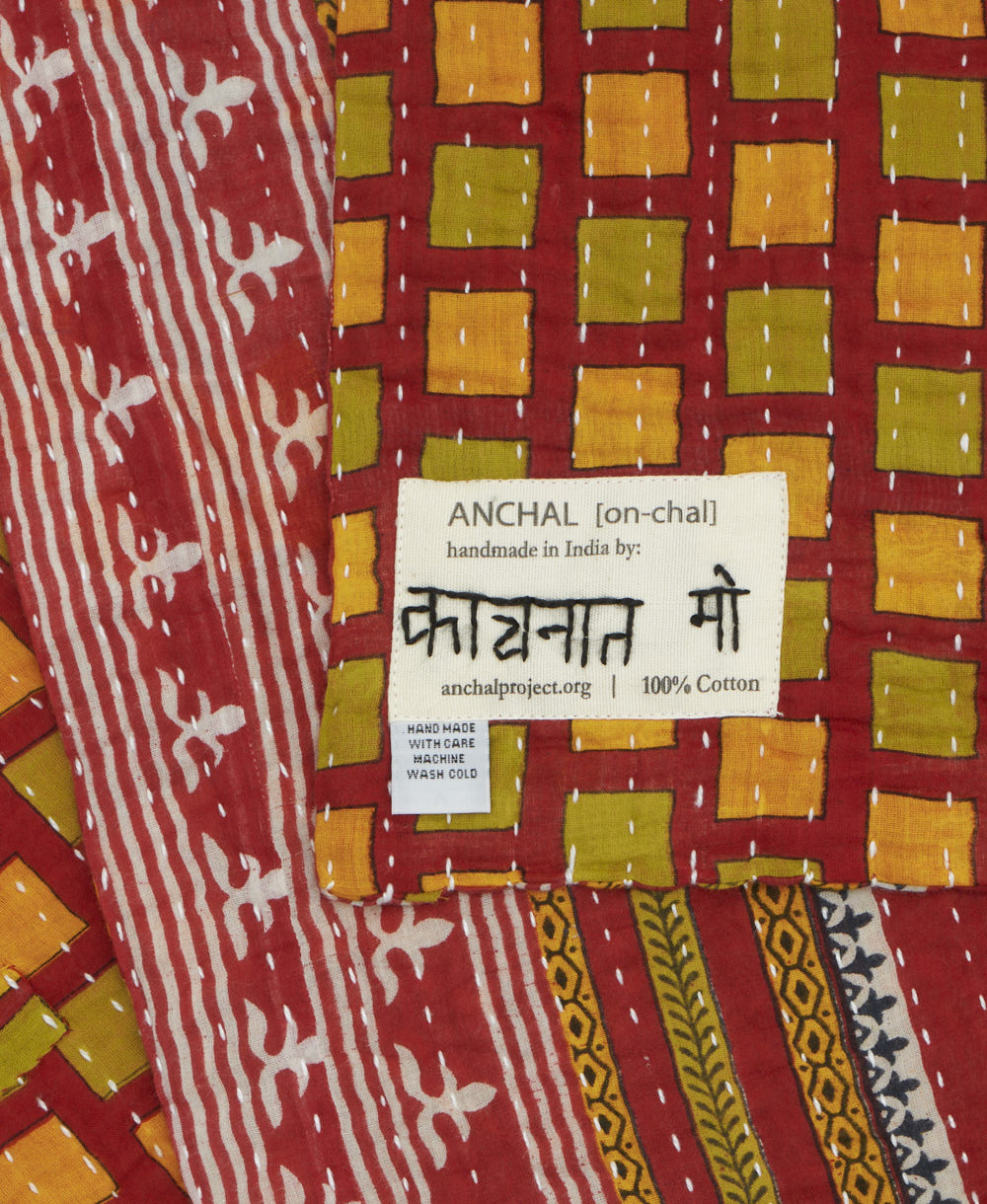small kantha blanket with signature of the maker on the tag