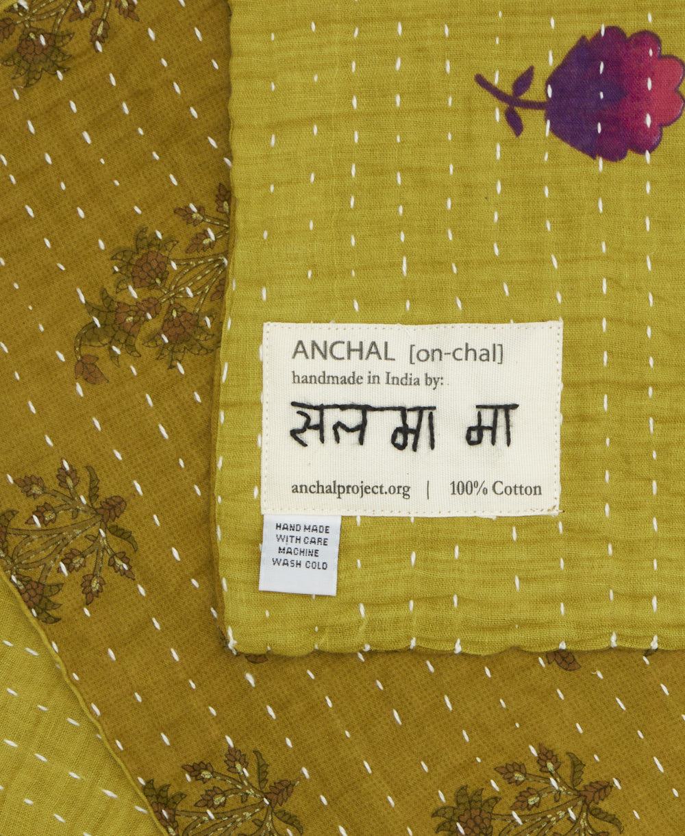 small kantha blanket with signature of the maker on the tag