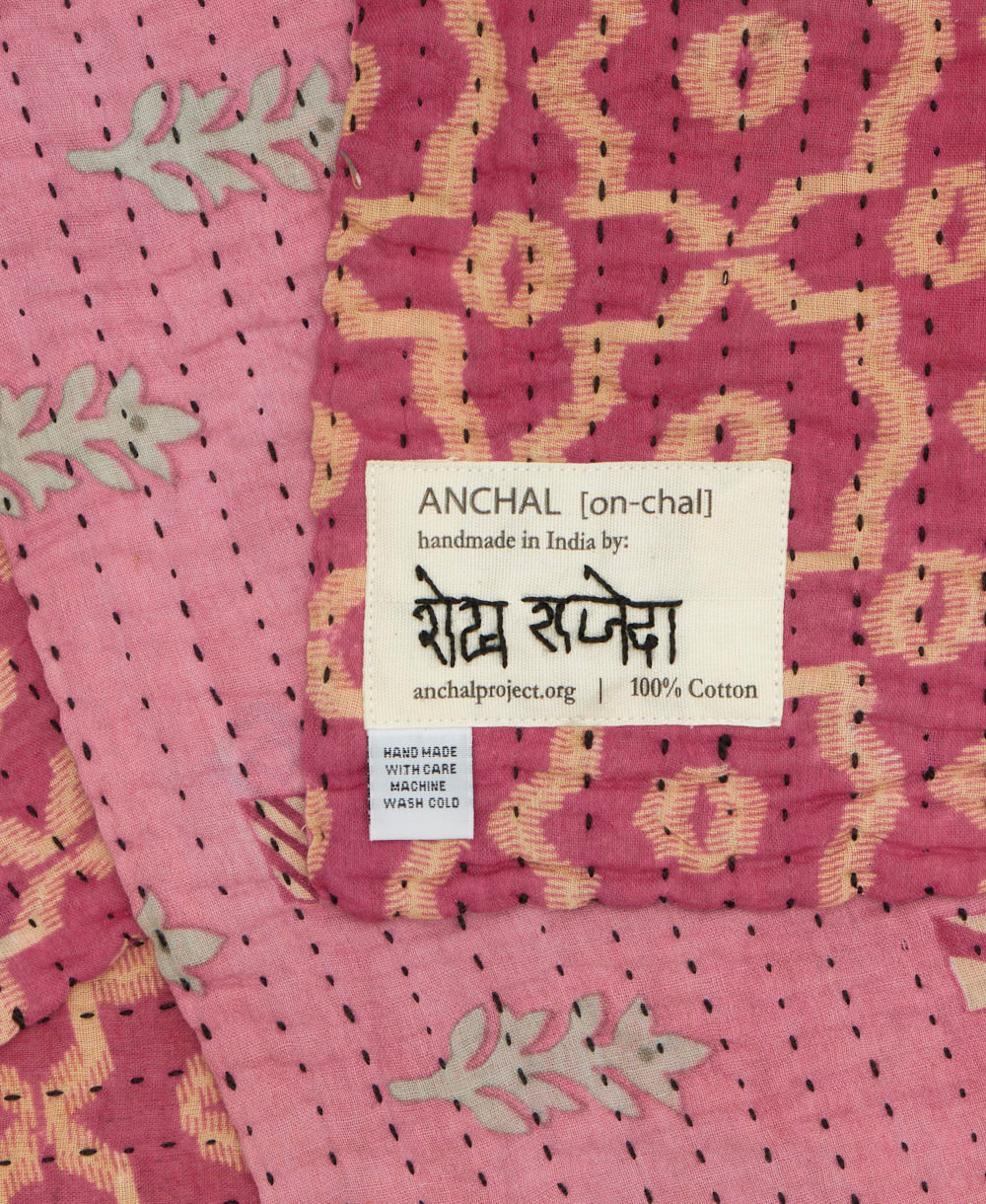 small kantha blanket with signature of the maker on the tag