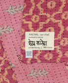 small kantha blanket with signature of the maker on the tag
