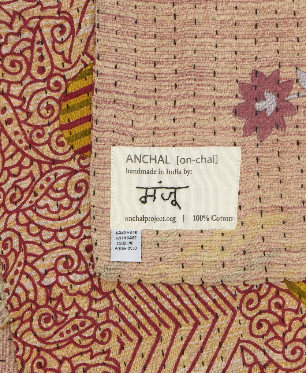 small kantha blanket with signature of the maker on the tag