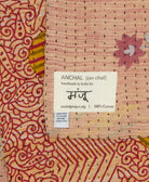 small kantha blanket with signature of the maker on the tag