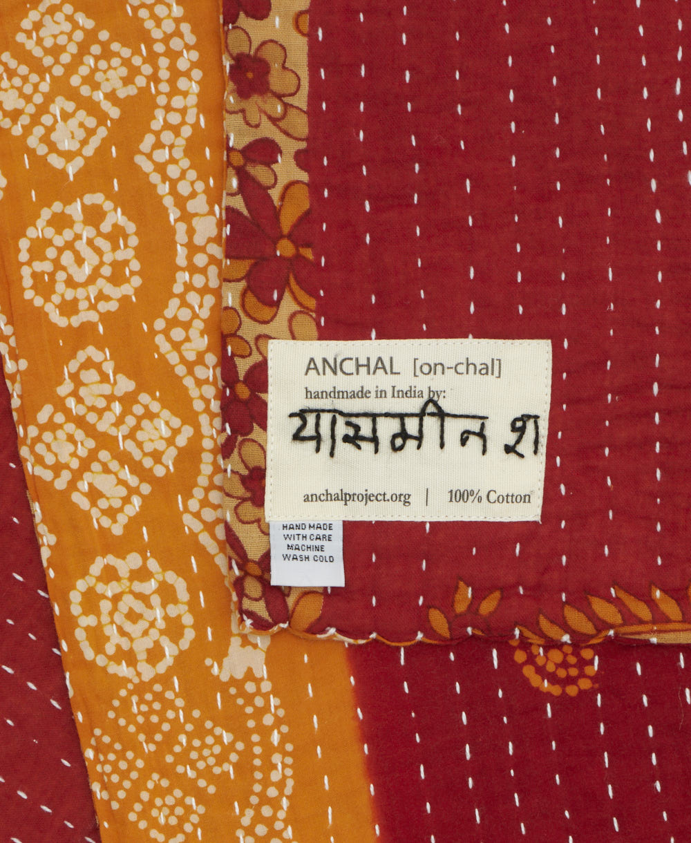 small kantha blanket with signature of the maker on the tag
