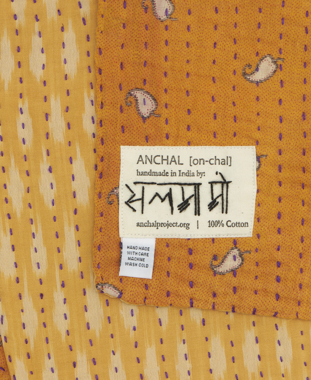 small kantha blanket with signature of the maker on the tag