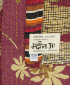 small kantha blanket with signature of the maker on the tag