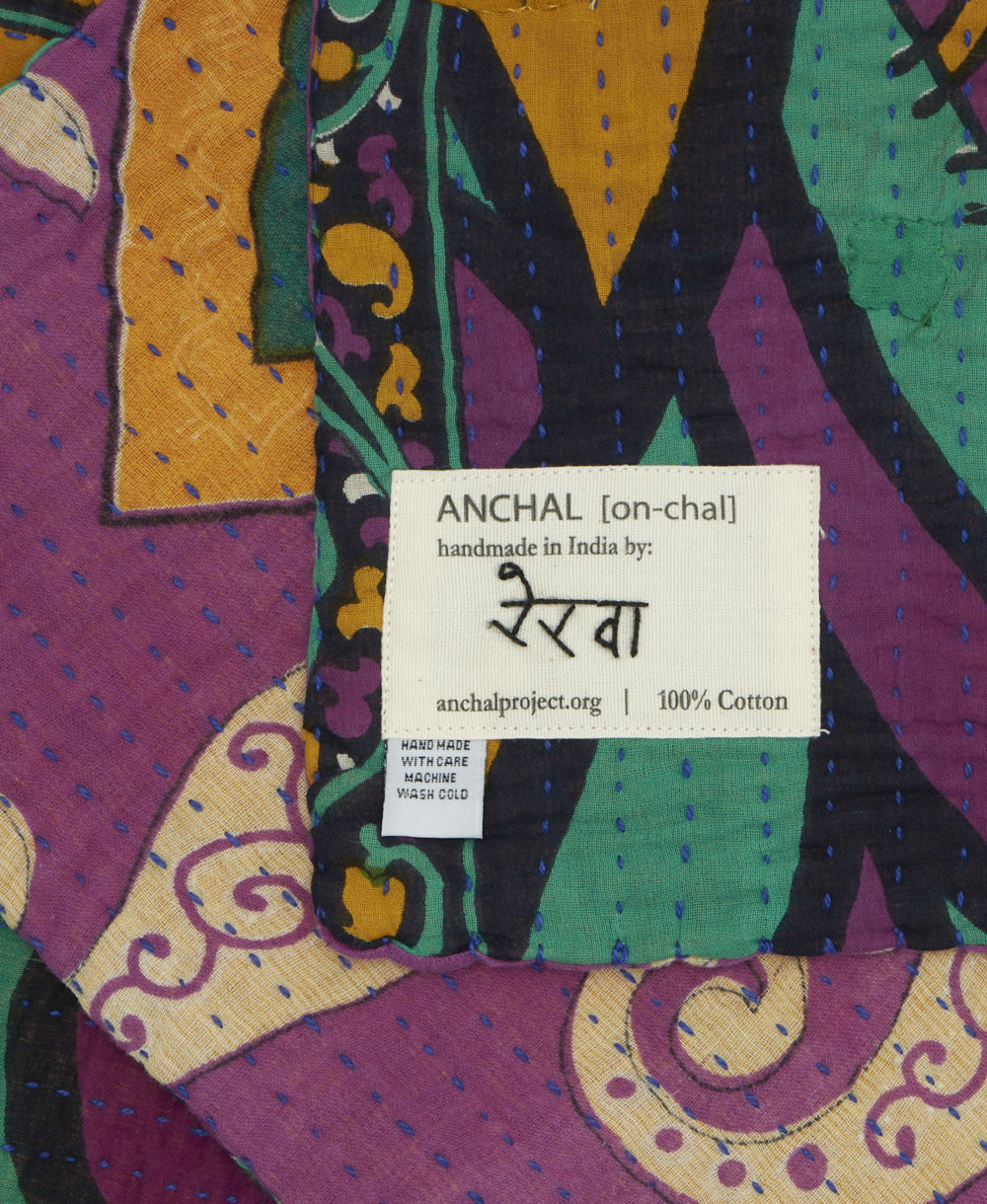 small kantha blanket with signature of the maker on the tag