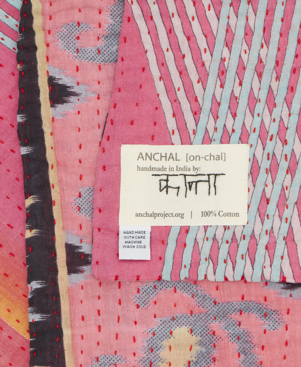small kantha blanket with signature of the maker on the tag
