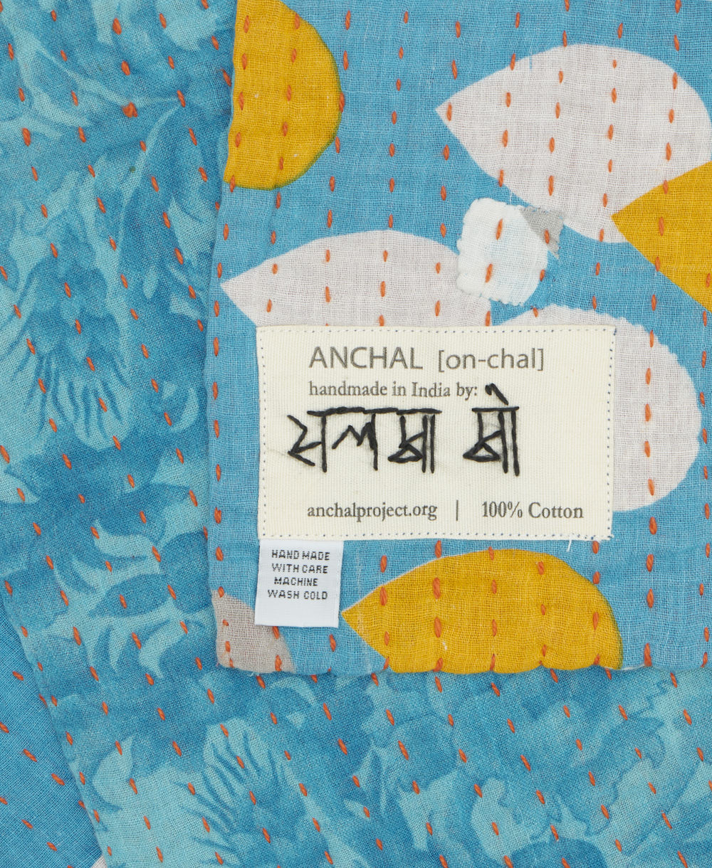 small kantha blanket with signature of the maker on the tag