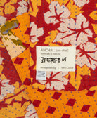 small kantha blanket with signature of the maker on the tag