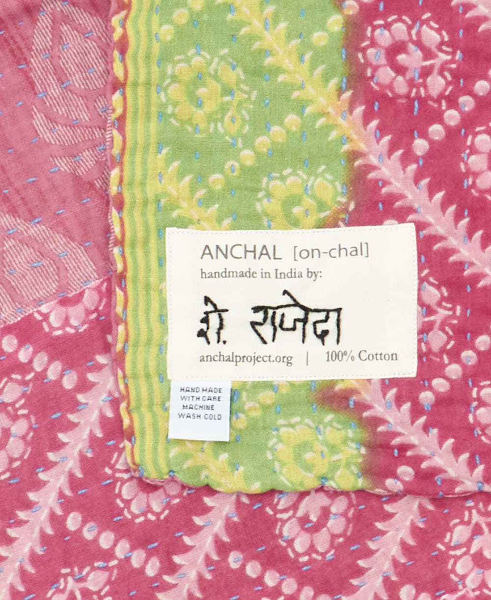 small kantha blanket with signature of the maker on the tag