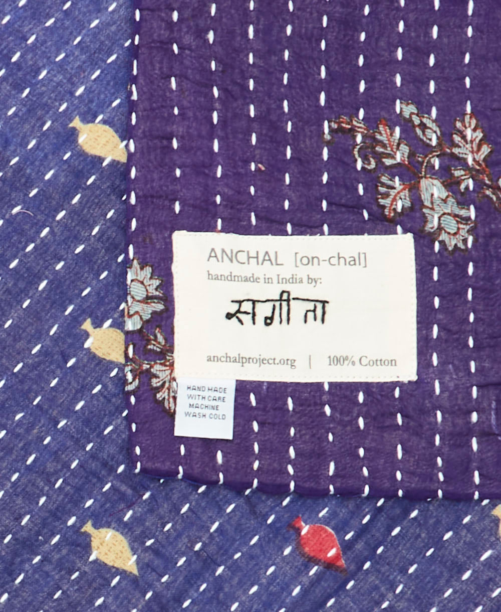 small kantha blanket with signature of the maker on the tag
