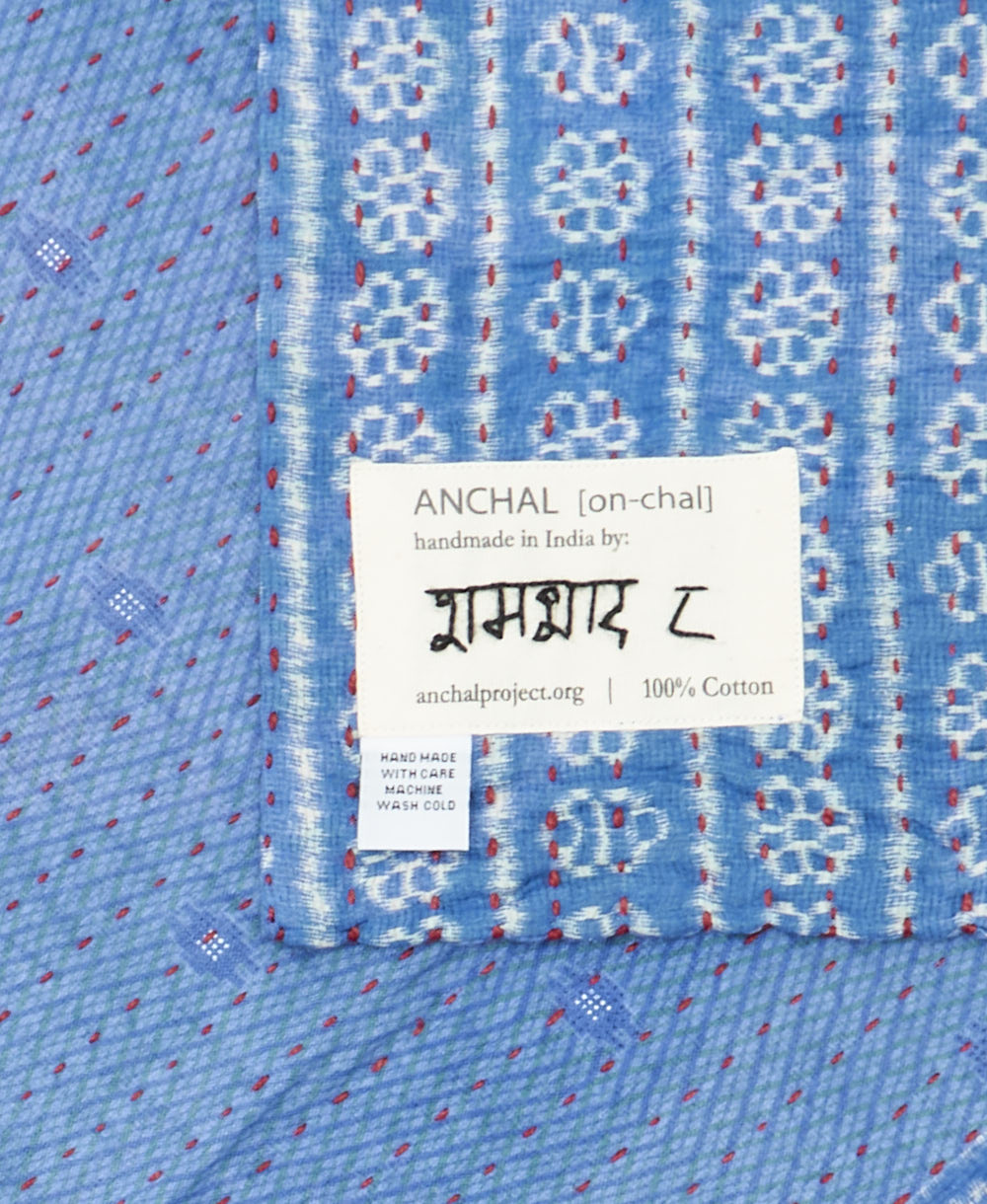small kantha blanket with signature of the maker on the tag