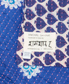 small kantha blanket with signature of the maker on the tag