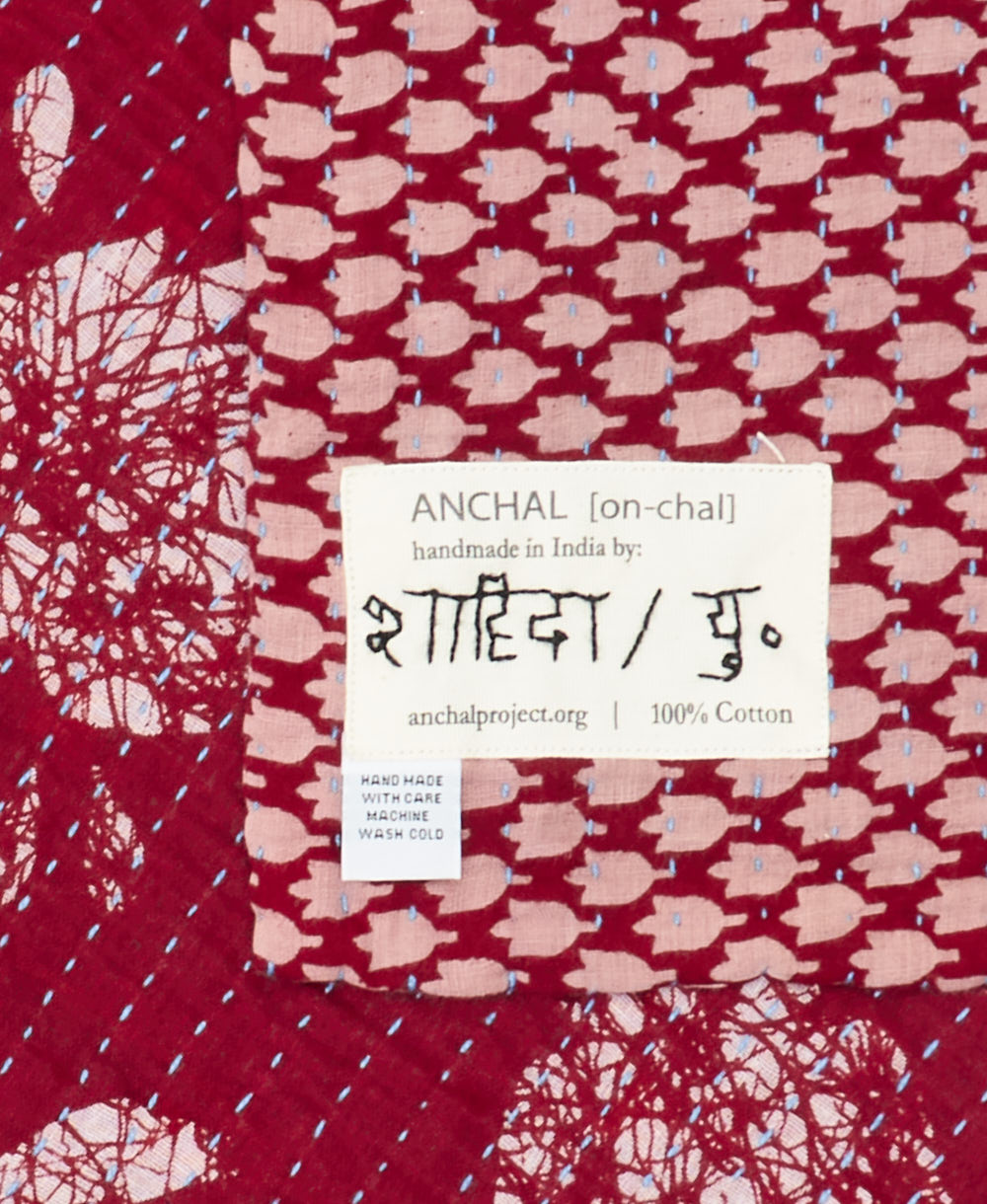 small kantha blanket with signature of the maker on the tag