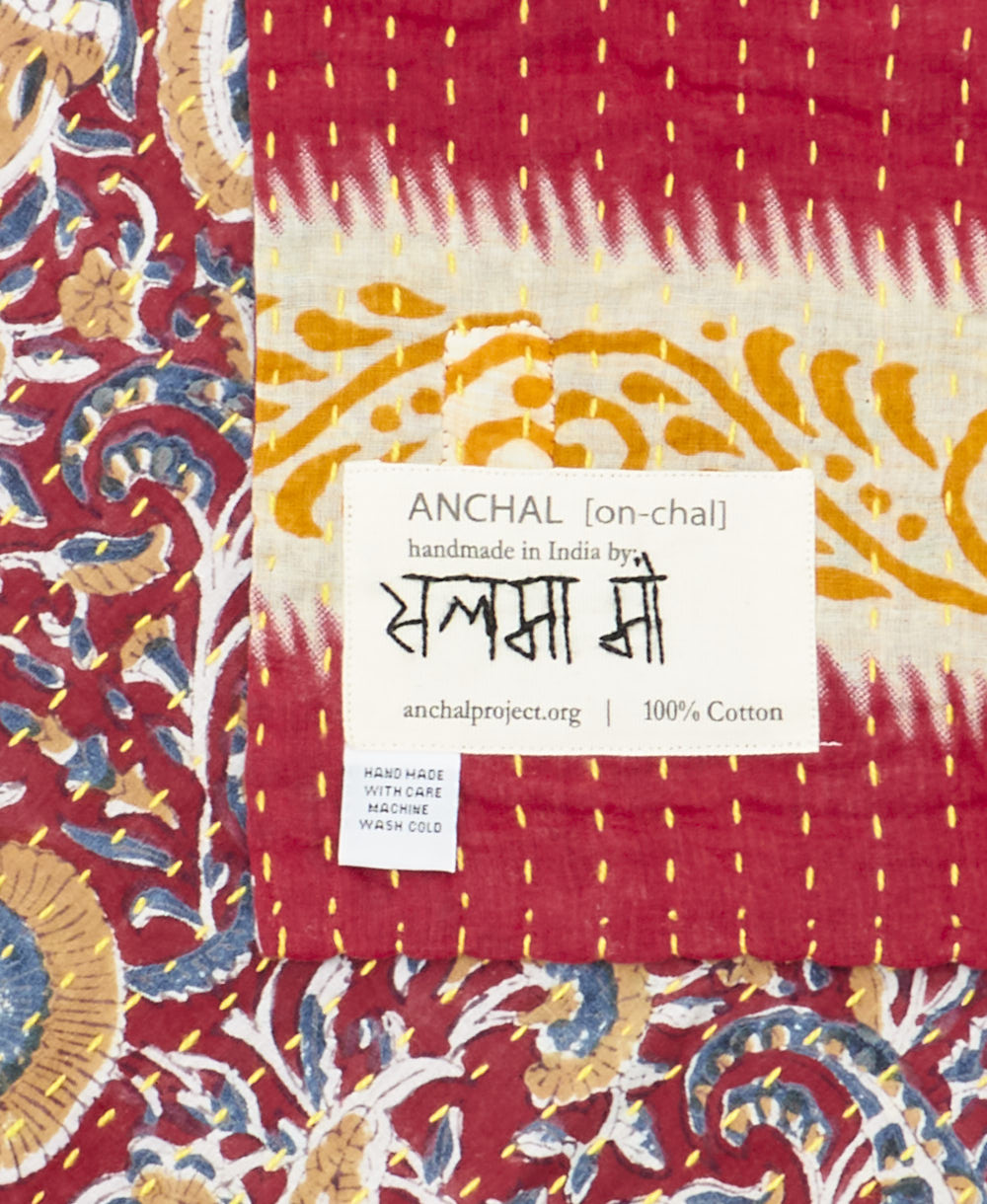 small kantha blanket with signature of the maker on the tag