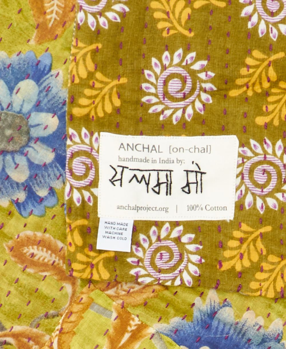 small kantha blanket with signature of the maker on the tag