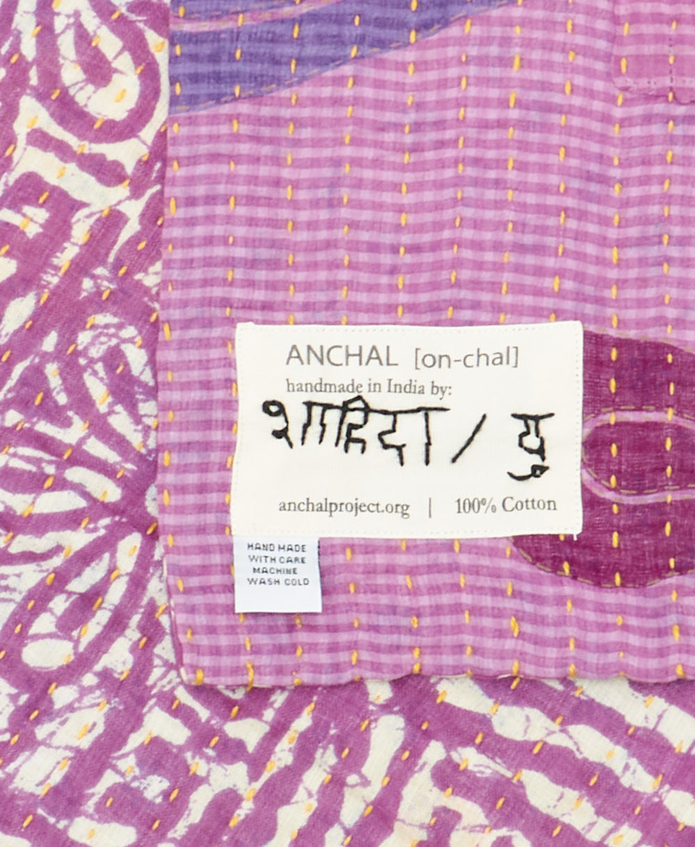 small kantha blanket with signature of the maker on the tag