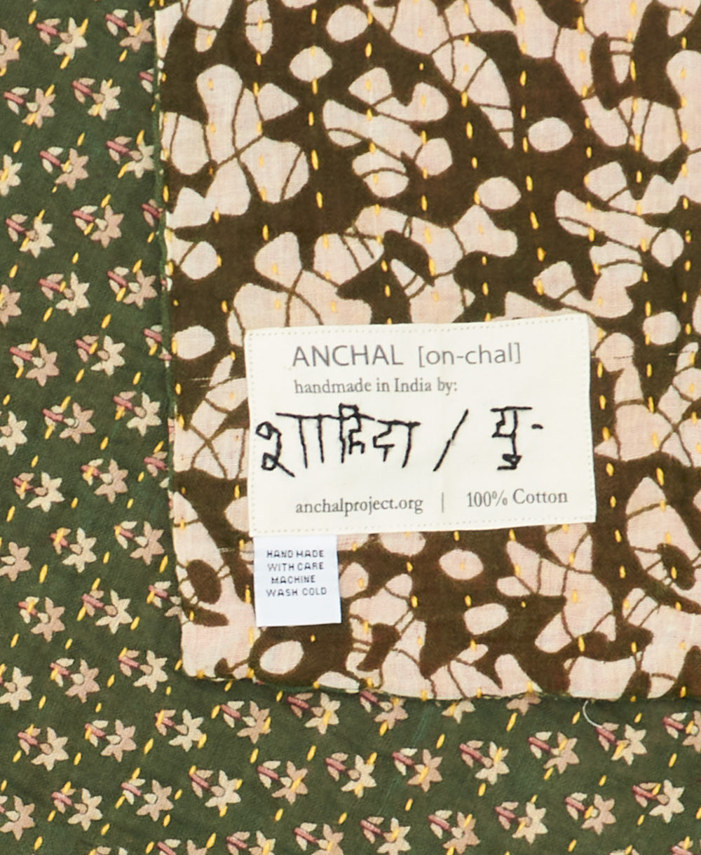 small kantha blanket with signature of the maker on the tag