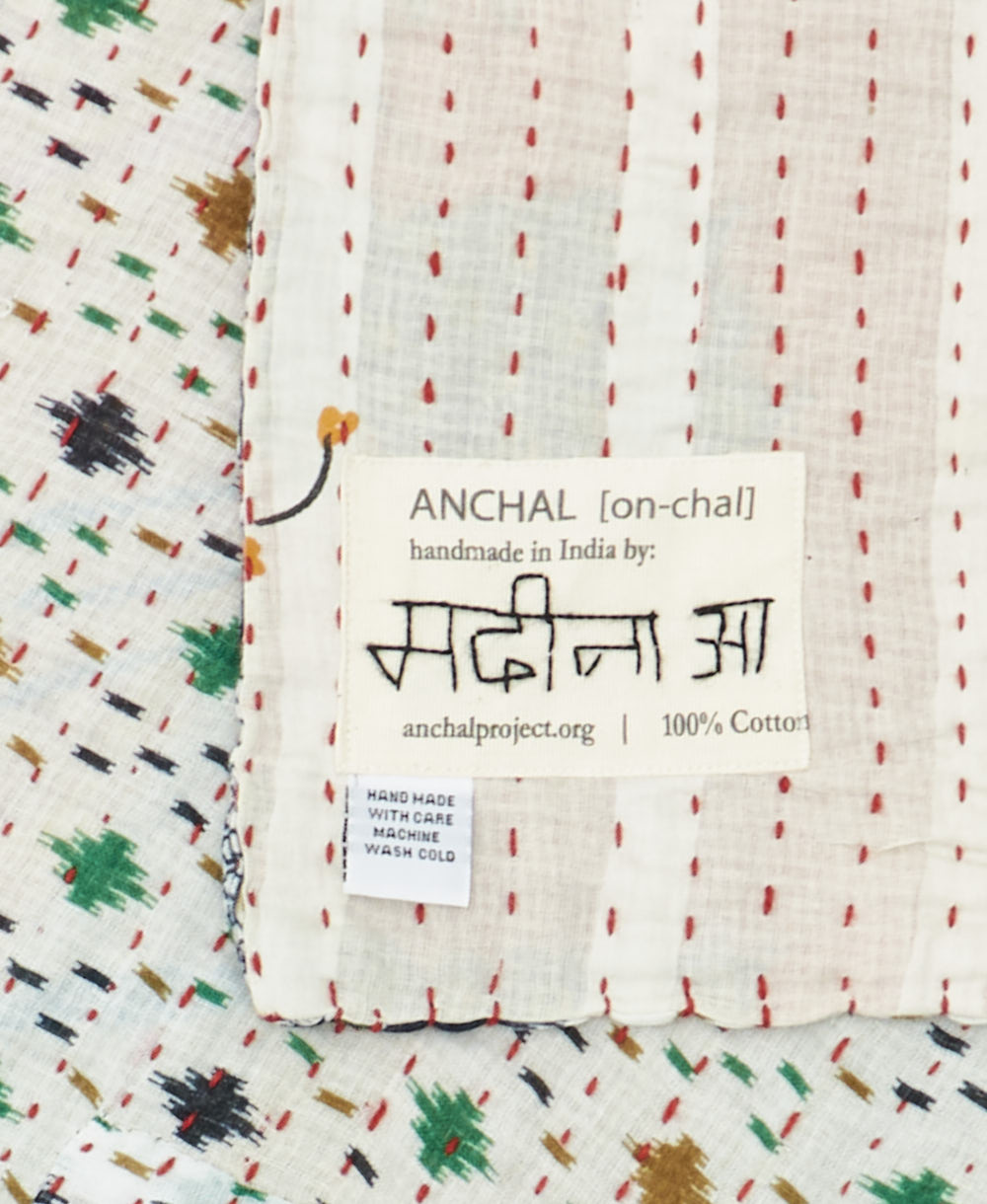small kantha blanket with signature of the maker on the tag
