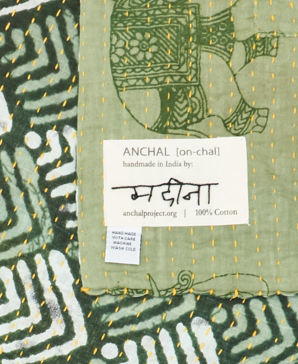 small kantha blanket with signature of the maker on the tag