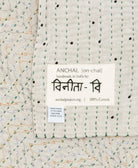 small kantha blanket with signature of the maker on the tag