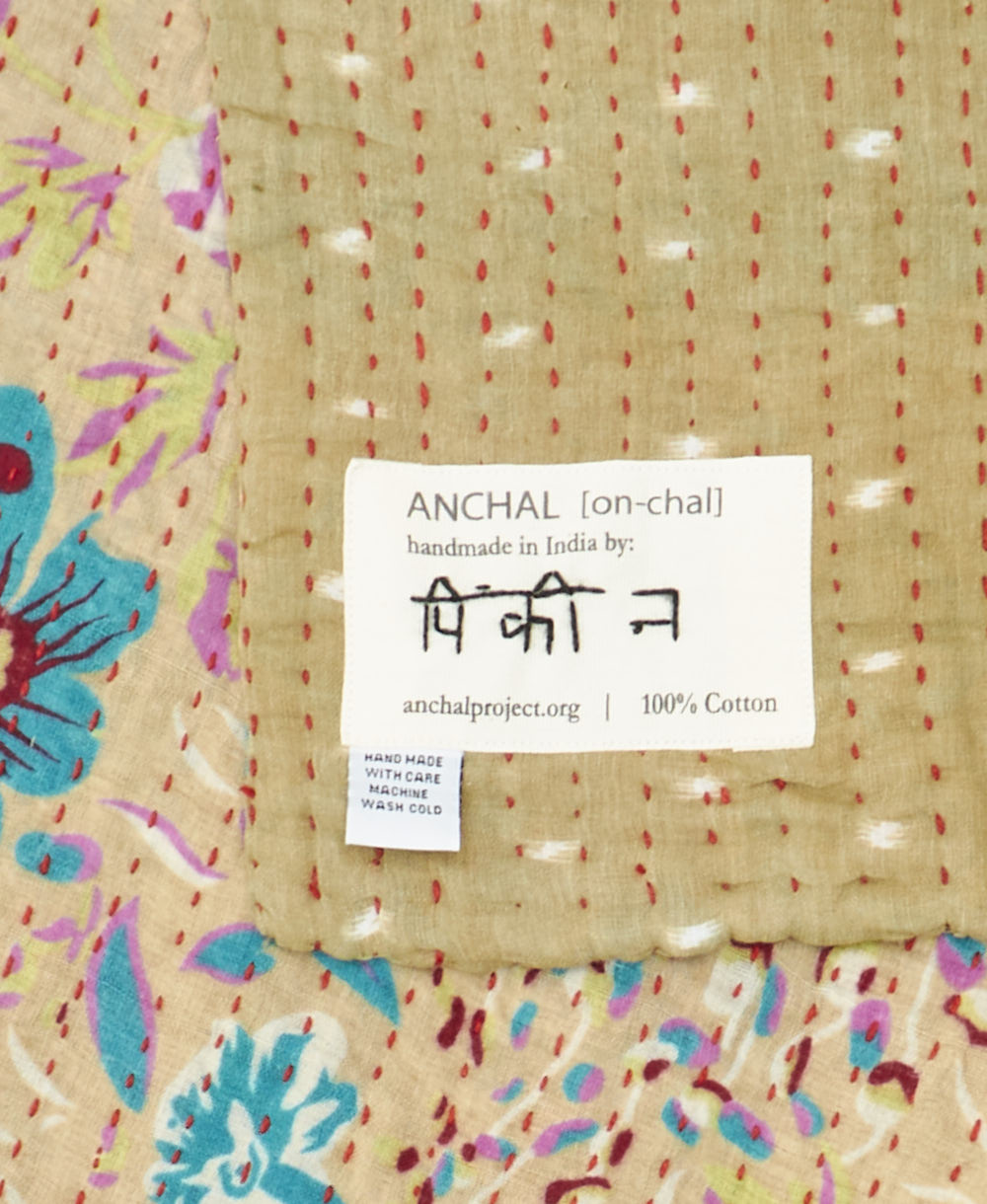 small kantha blanket with signature of the maker on the tag