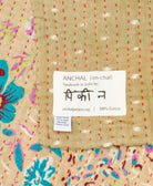 small kantha blanket with signature of the maker on the tag